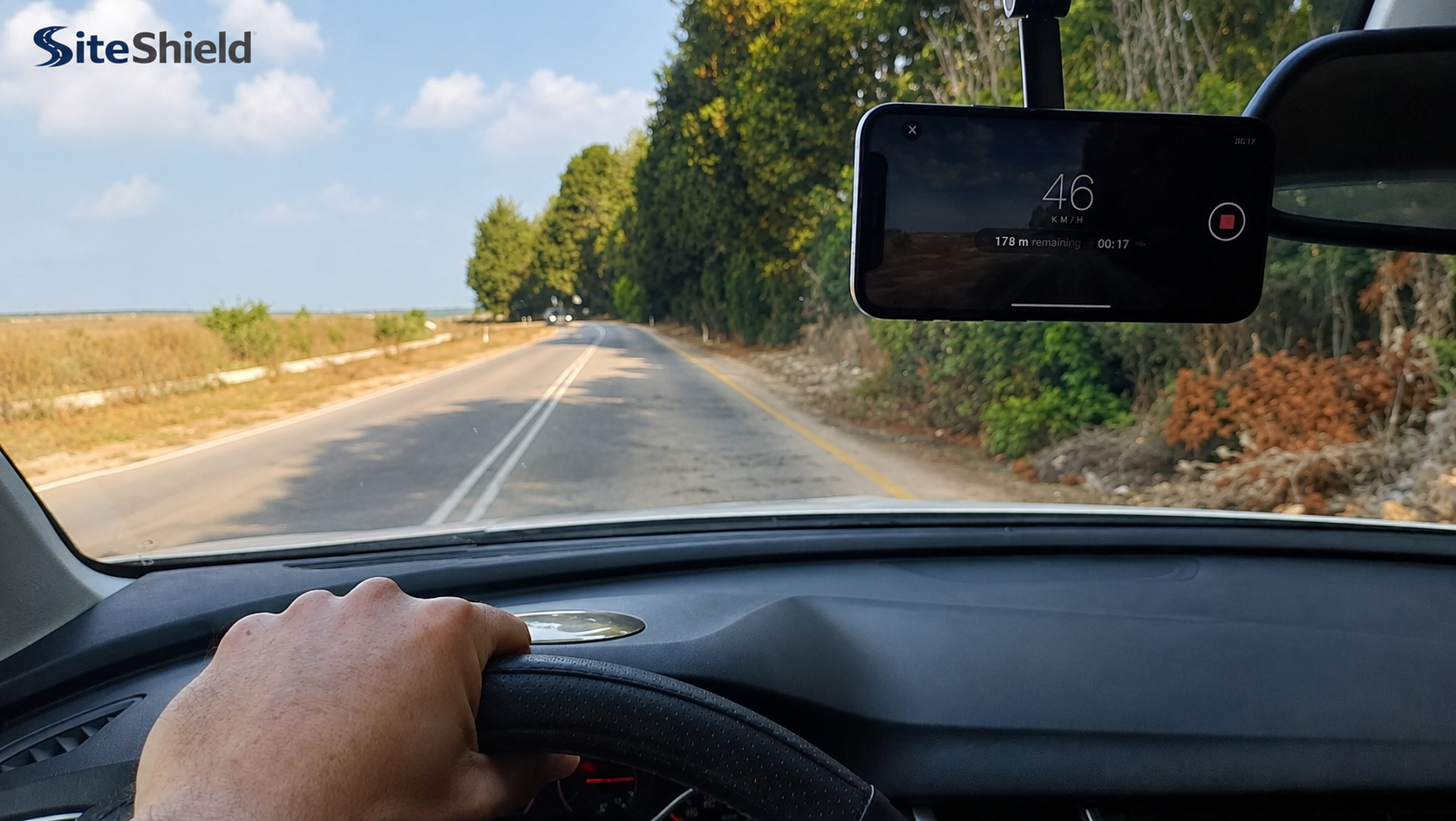 Smartphone mounted inside a vehicle capturing field video on an infrastructure road